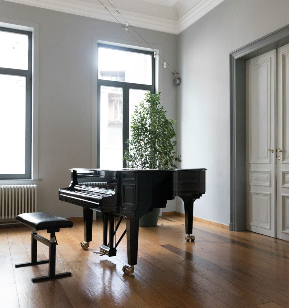 Professional movers handling a piano