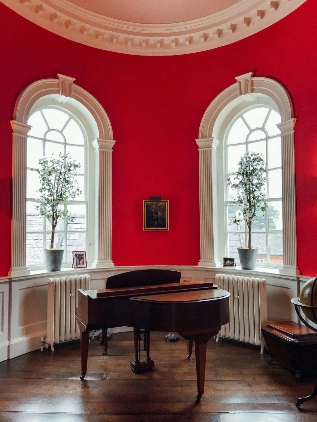 Upright piano in a red living room